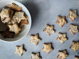 Flat lay of star-shaped homemade cookies in a bowl, perfect for Christmas treats.